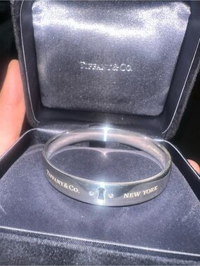Tiffany & Co. Silver Keyhole Bangle with Gold Lettering